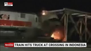 Train in Indonesia bursts into flames after colliding with truck [upl. by Cowden245]