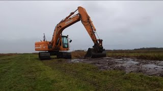 Dredging ditches with the Doosan DX180 [upl. by Haneekas]