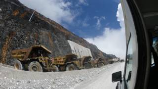 Line of overburden trucks waiting disposal  Grasberg Mine [upl. by Grubman]