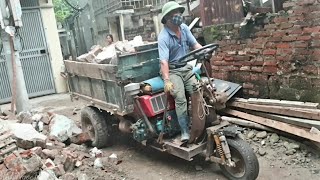 Small excavator scoops bricks onto threewheeled vehicle [upl. by Kacerek]