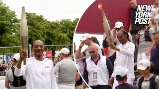 WATCH Snoop Dogg carries Olympic torch ahead of 2024 Opening Ceremony [upl. by Lesde669]