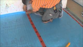 Installing the Underlayment for Laminate Flooring Installation on Wood Mryoucandoityourself [upl. by Abocaj]