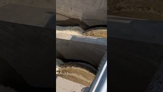 Aerial view of dam spillway water release [upl. by Nunnery]