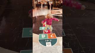 At the mall Maya plays hopscotch gameВ торговом центре Майя играет в игру quotклассикиquot shorts [upl. by Dorris]