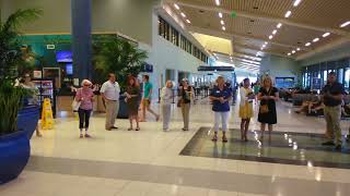 Ukulele Orchestra of St Andrews plays for arriving passengers [upl. by Morganne]