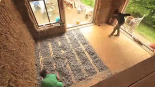 Eco insulation being installed in a straw bale home [upl. by Bollay480]