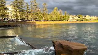 Early morning at Terrigal Dark storm clouds Bright sunlight Kayakers and paddlers [upl. by Yance982]