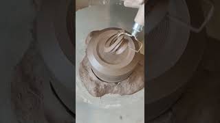 Ceramics artist is trimming the base of a pottery cup [upl. by Hulton414]