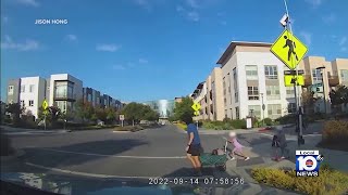 A little girl is almost hit by a car while trying to cross the street [upl. by Florian]