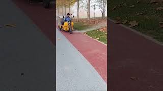 The process of clearing fallen leaves on sidewalks with high pressure water guns [upl. by Ettevey86]