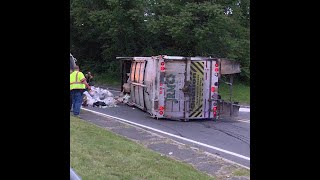 Trash truck rolls over spills debris all over road [upl. by Kcirdle]