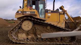 CAT D6 dozer at work levelling stone on a road construction site 2 [upl. by Gnouv95]