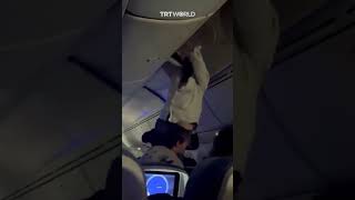 Man rescued from plane’s overhead compartment after turbulence [upl. by Arihat]