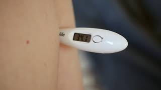 An axillary armpit temperature is measured with a electric thermometer Free HD video footage [upl. by Gibbon]