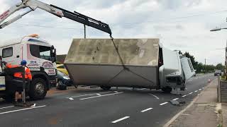 Watch as overturned lorry is dragged off new car display [upl. by Yrelbmik575]