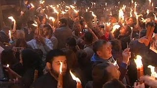 Thousands gather at the Holy Sepulchre in Jerusalem for the start of Orthodox Easter [upl. by Enitnelav]