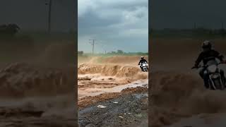 Daring Biker Speeds Through Flooded Road HeartStopping Ride FloodedRoad Dangerousride [upl. by Mou774]