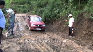 Maruti Suzuki car struggles to cross muddy road  men place stones to let car pass in Ukhimath [upl. by Eilasor]